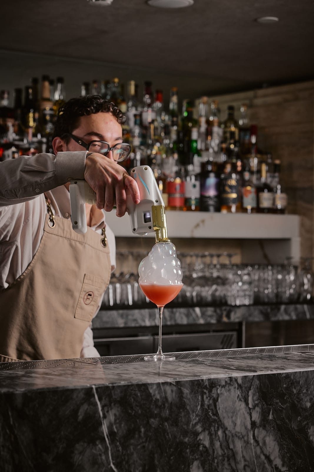 A bartender crafting a cocktail at Fleet Rooftop Bar