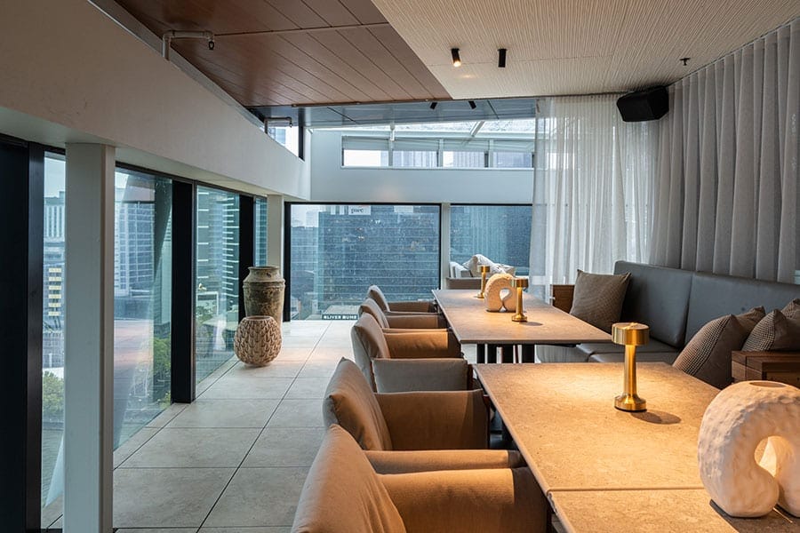 Indoor terrace seating with Flinders Street views at Fleet Rooftop Bar