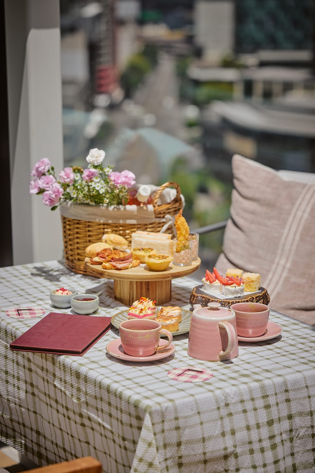 A picnic-style high tea set against Fleet's rooftop city views